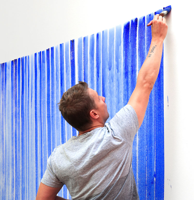 Jeppe painting a wall